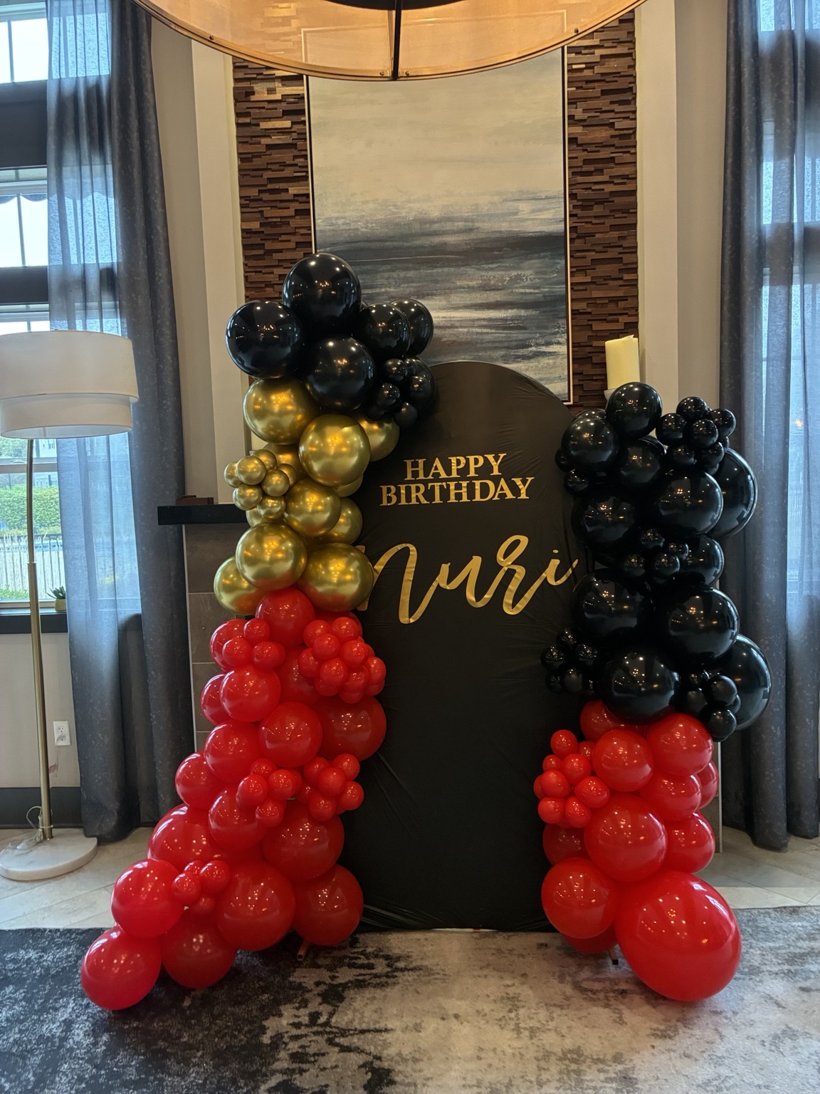 Black, gold and red balloon décor by Lovelee LuxDecor